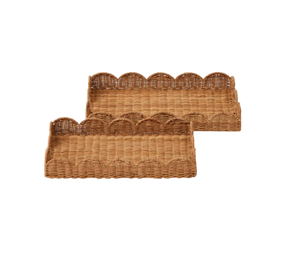 Two woven baskets with scalloped edges on a white background