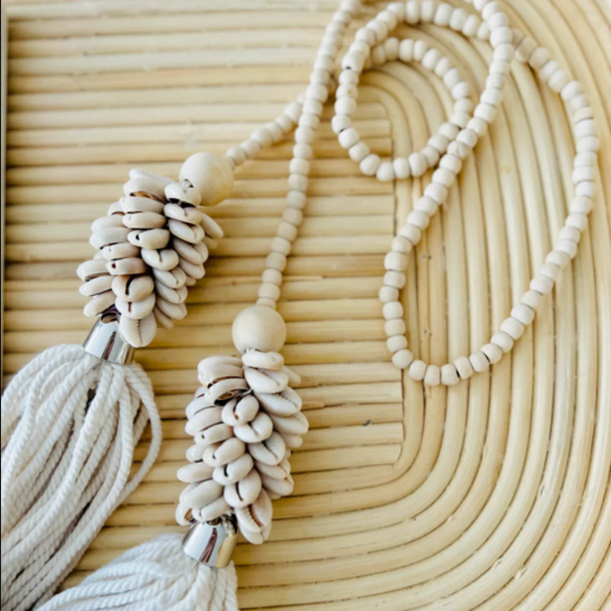 Necklace with tassels and beads on a woven surface