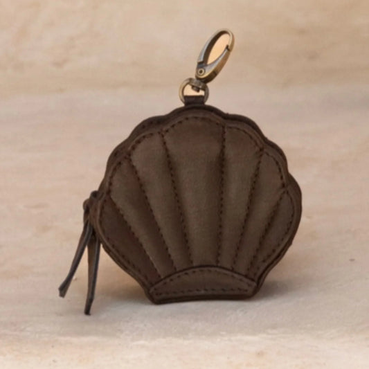 Brown shell-shaped purse with a gold clasp on a beige background