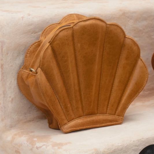 Brown shell-shaped handbag on a marble surface