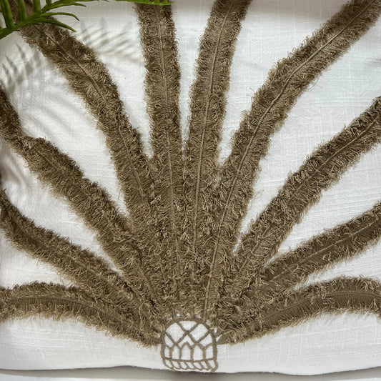 Cushion with textured brown leaf design on a white background