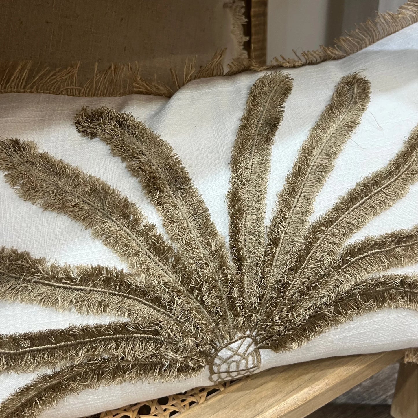 Cushion with textured brown leaf design on a white background