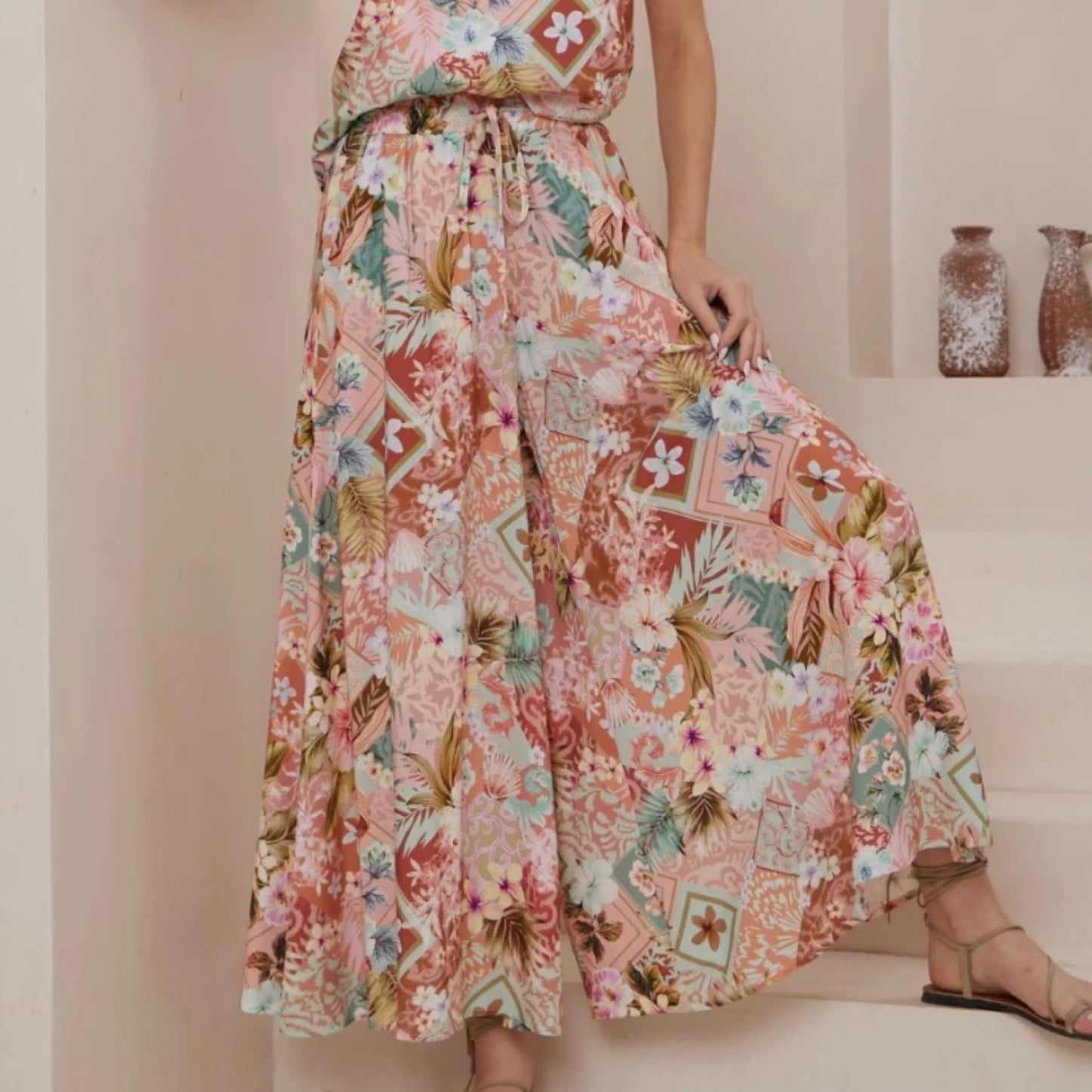 Person wearing a floral dress with a neutral background