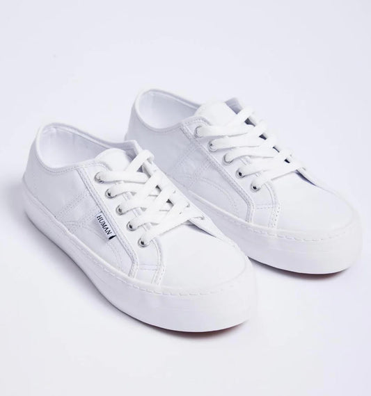 Pair of white sneakers on a light gray background