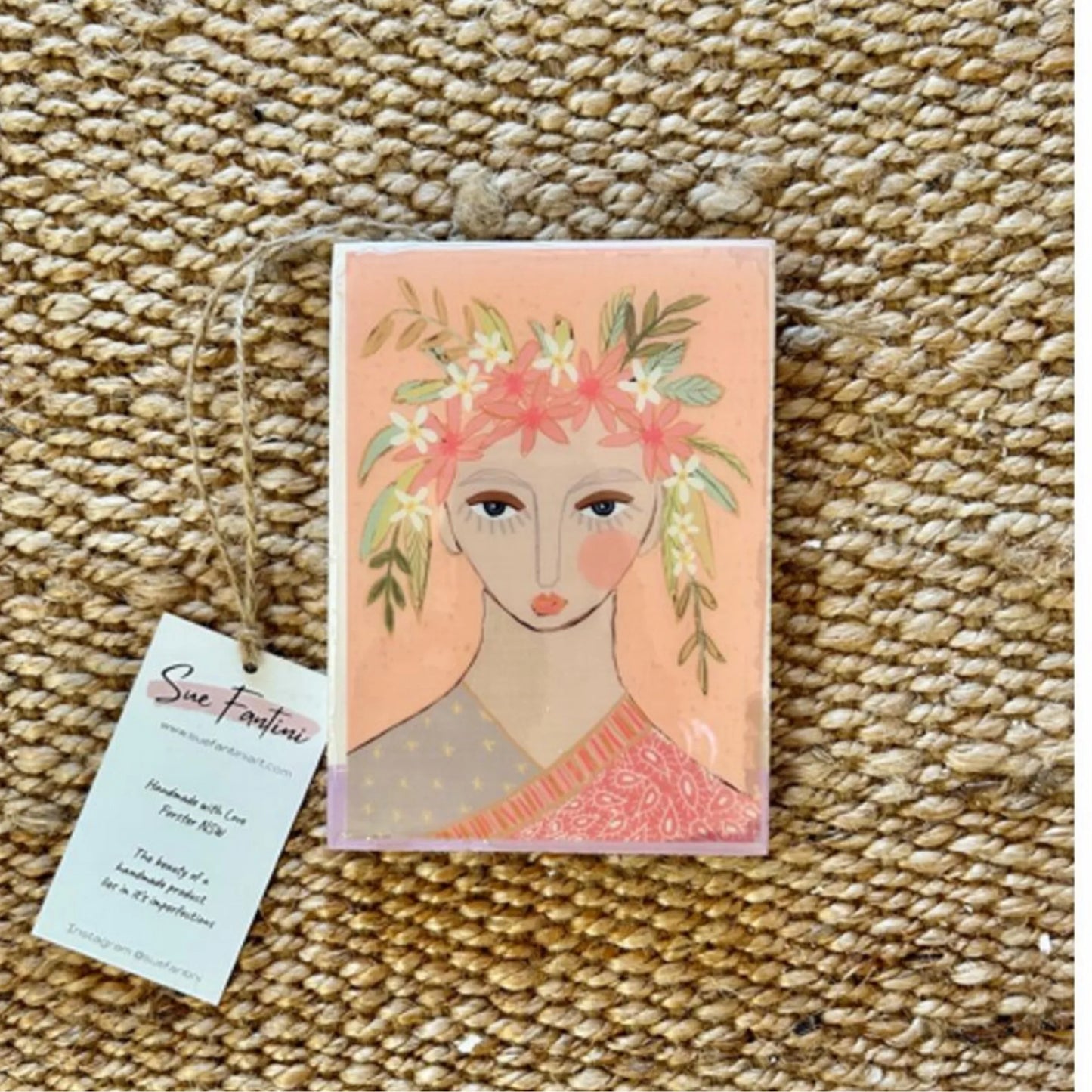 Decorative tile with a floral design on a textured surface