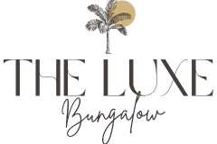 Logo for 'The Luxe Bungalow' with a palm tree and sun design.