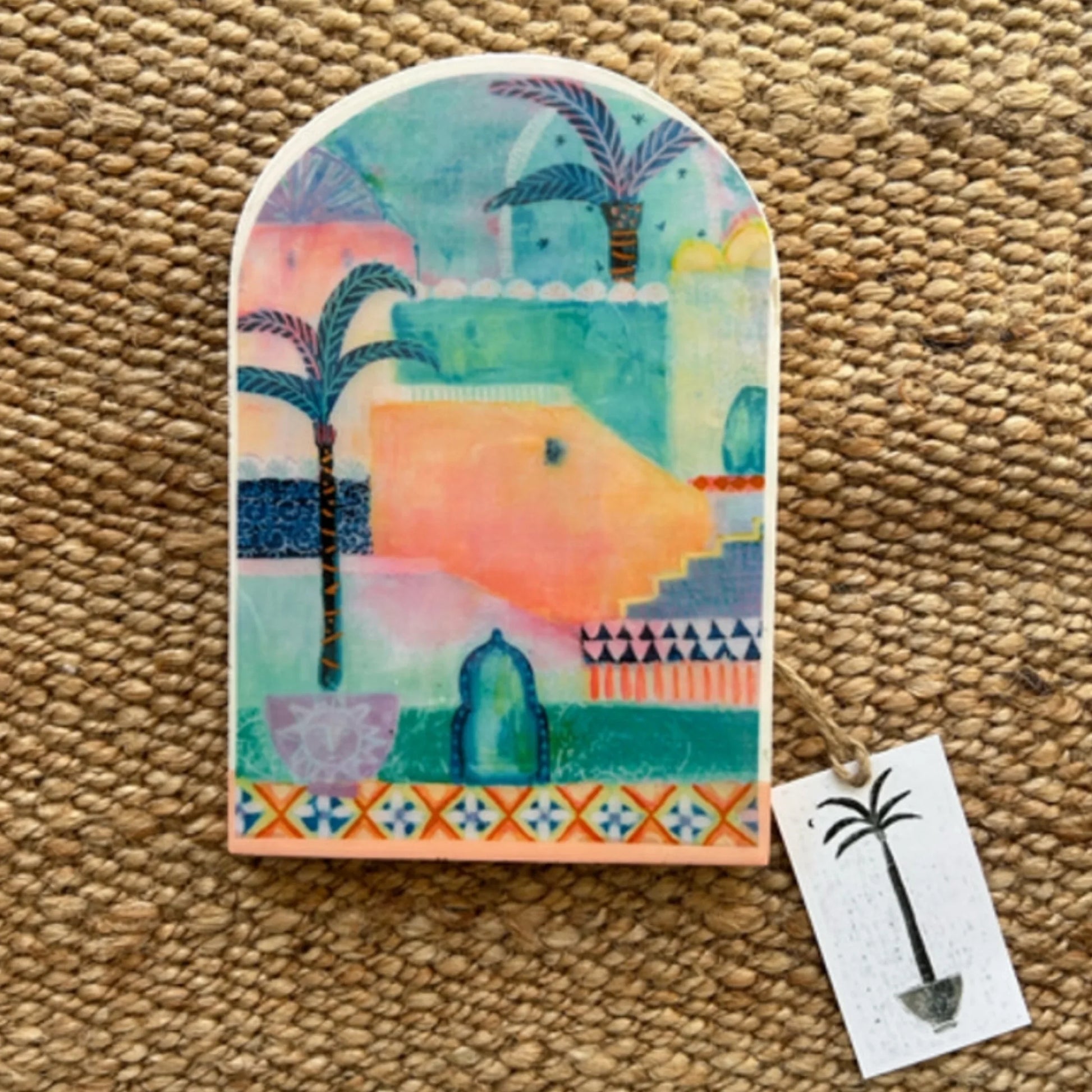 Decorative tile with a colourful design on a textured surface