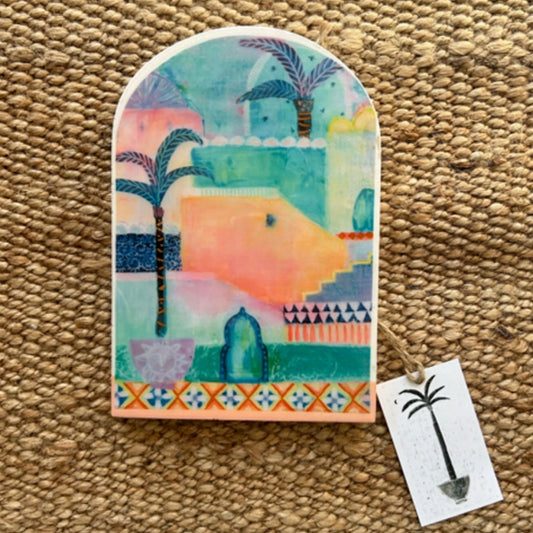Decorative tile with a colourful design on a textured surface