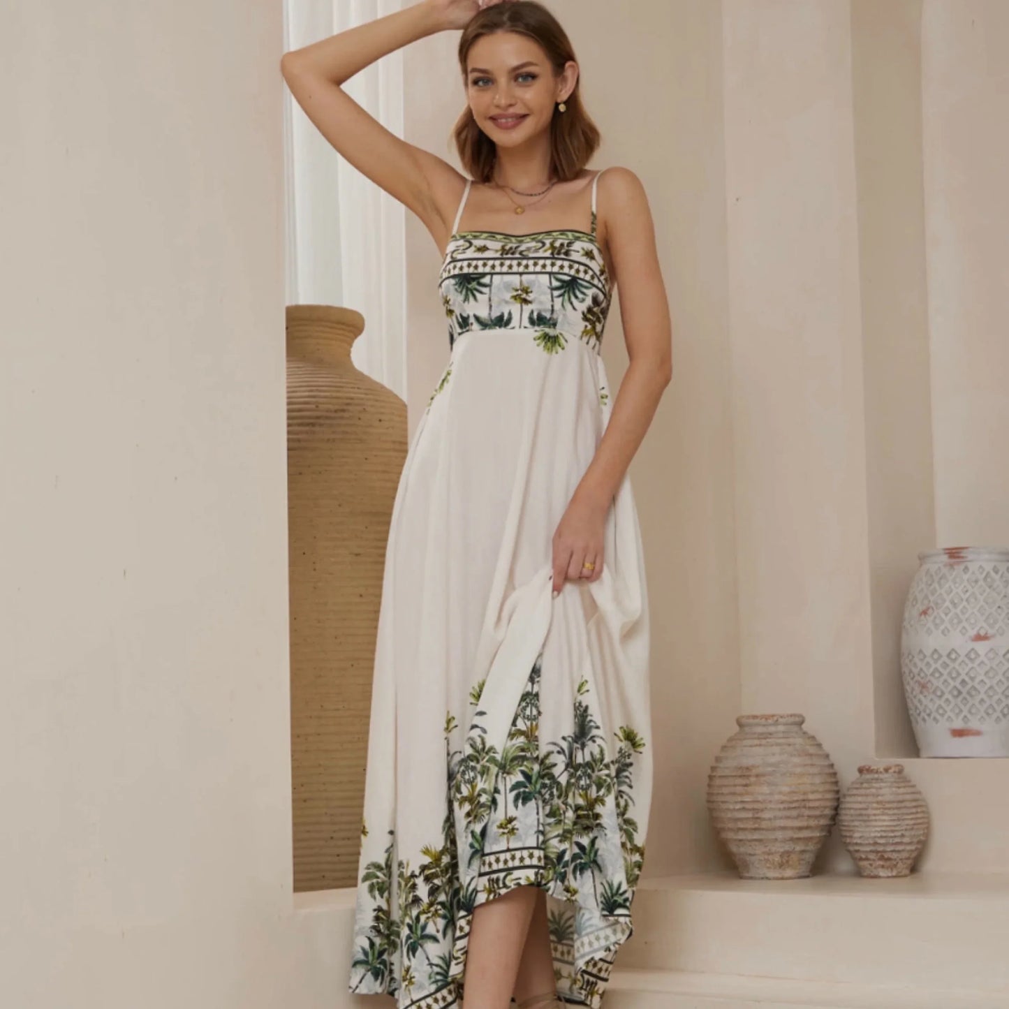 Woman wearing a white dress with floral patterns in a home setting