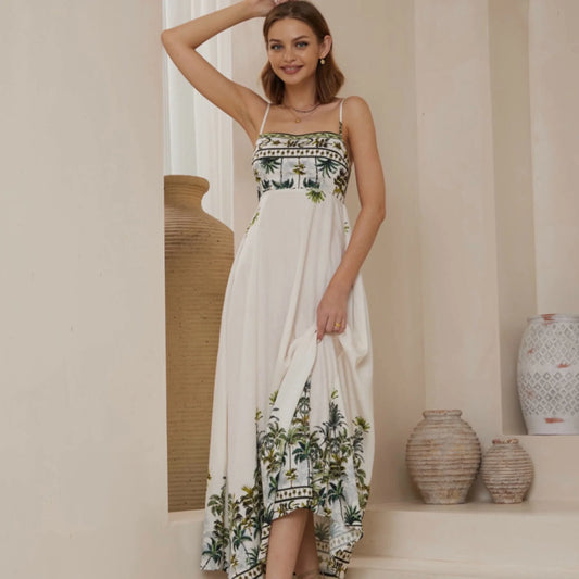 Woman wearing a white dress with floral patterns in a home setting
