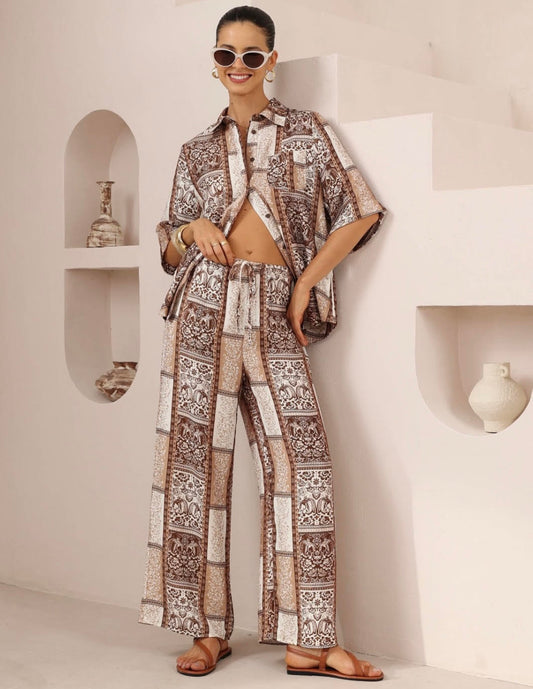 Woman wearing a patterned outfit in a minimalistic room.
