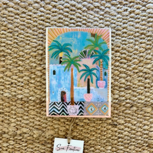 Decorative tile with palm tree design on a textured surface
