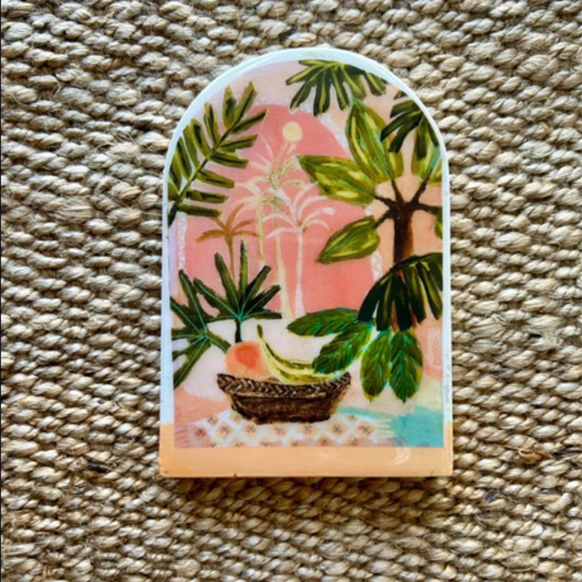 Decorative tile with tropical plant design on a textured surface
