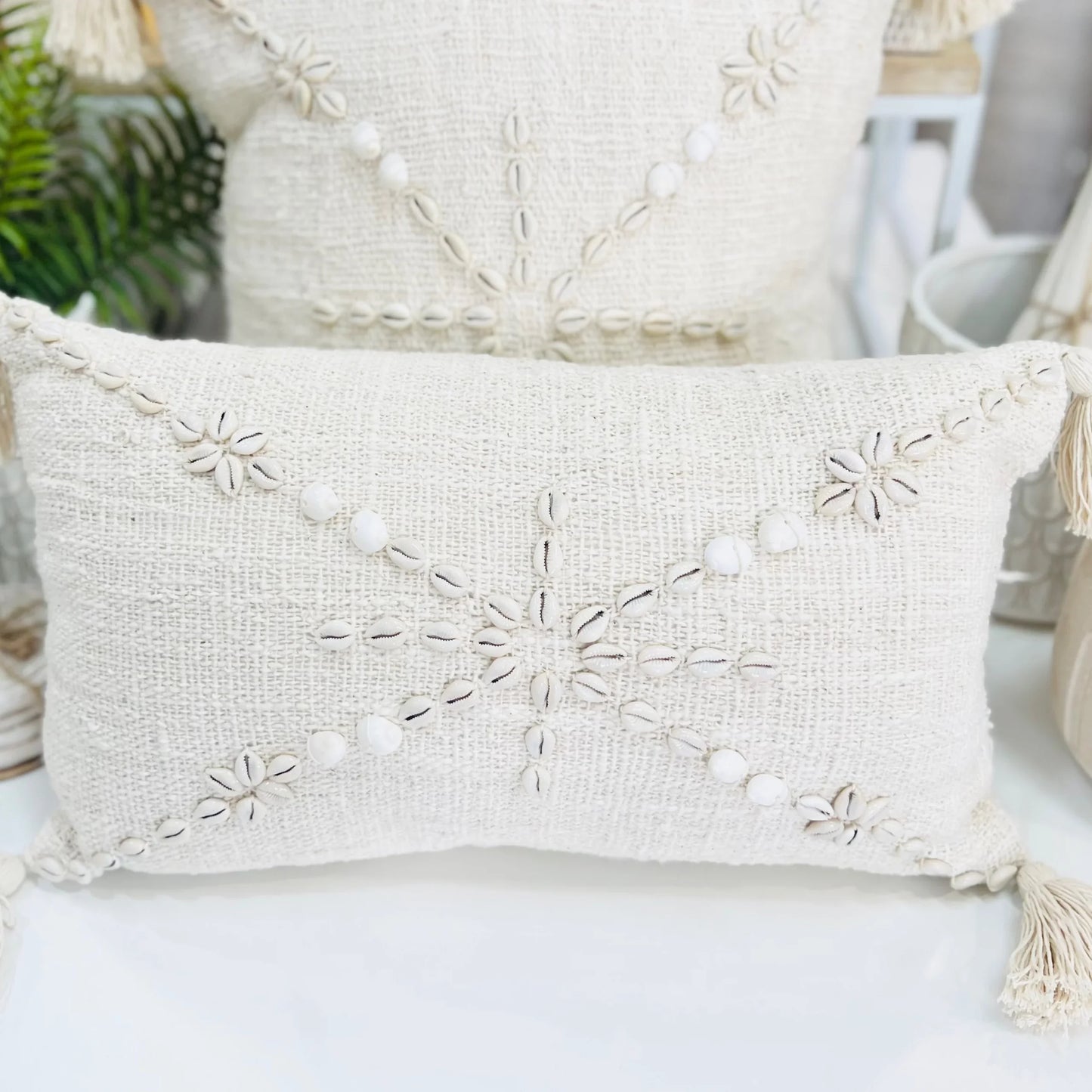 Decorative pillow with embroidered patterns on a white surface