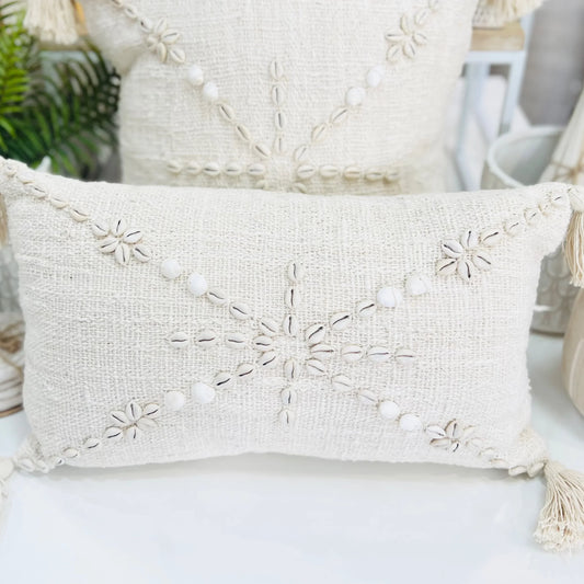 Decorative pillow with embroidered patterns on a white surface