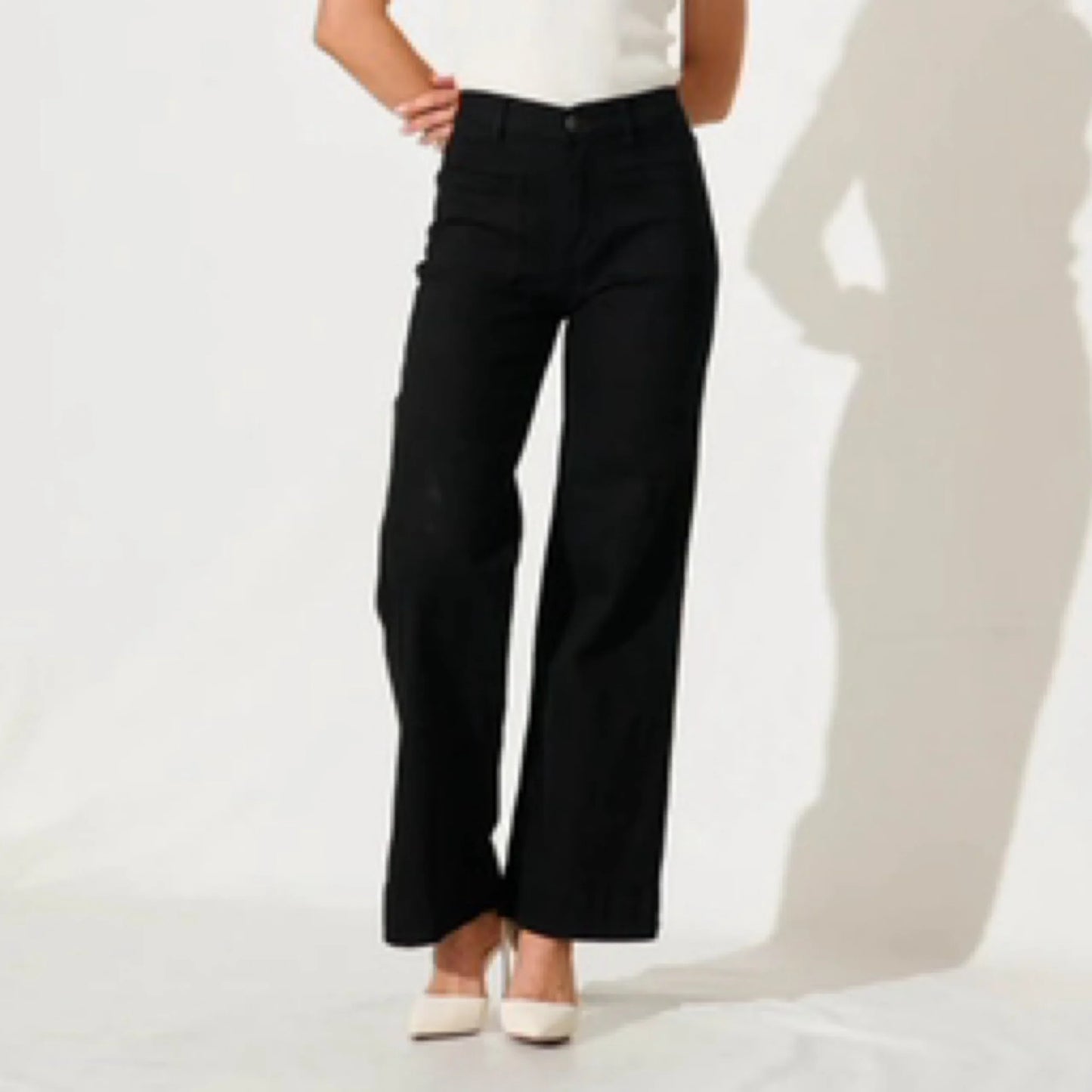 Person wearing black pants on a white background