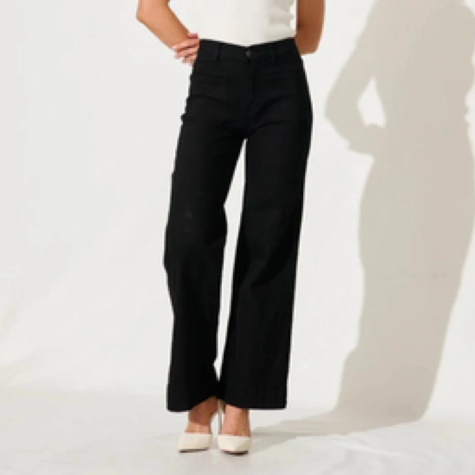 Person wearing black pants on a white background