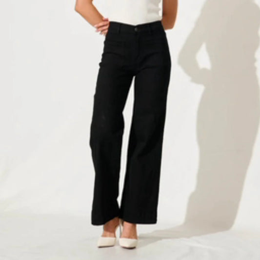 Person wearing black pants on a white background