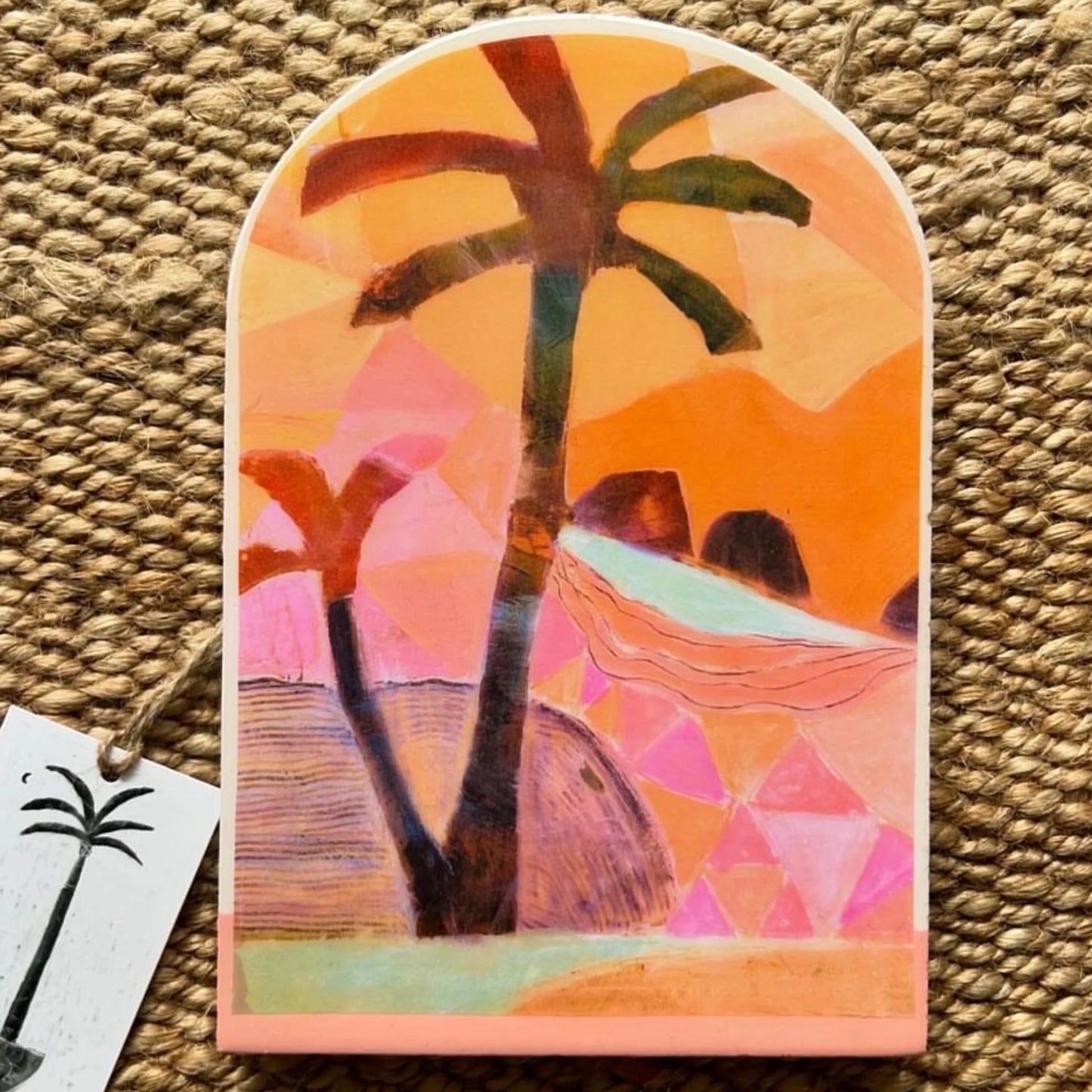 Colorful palm tree and hammock design on a textured surface
